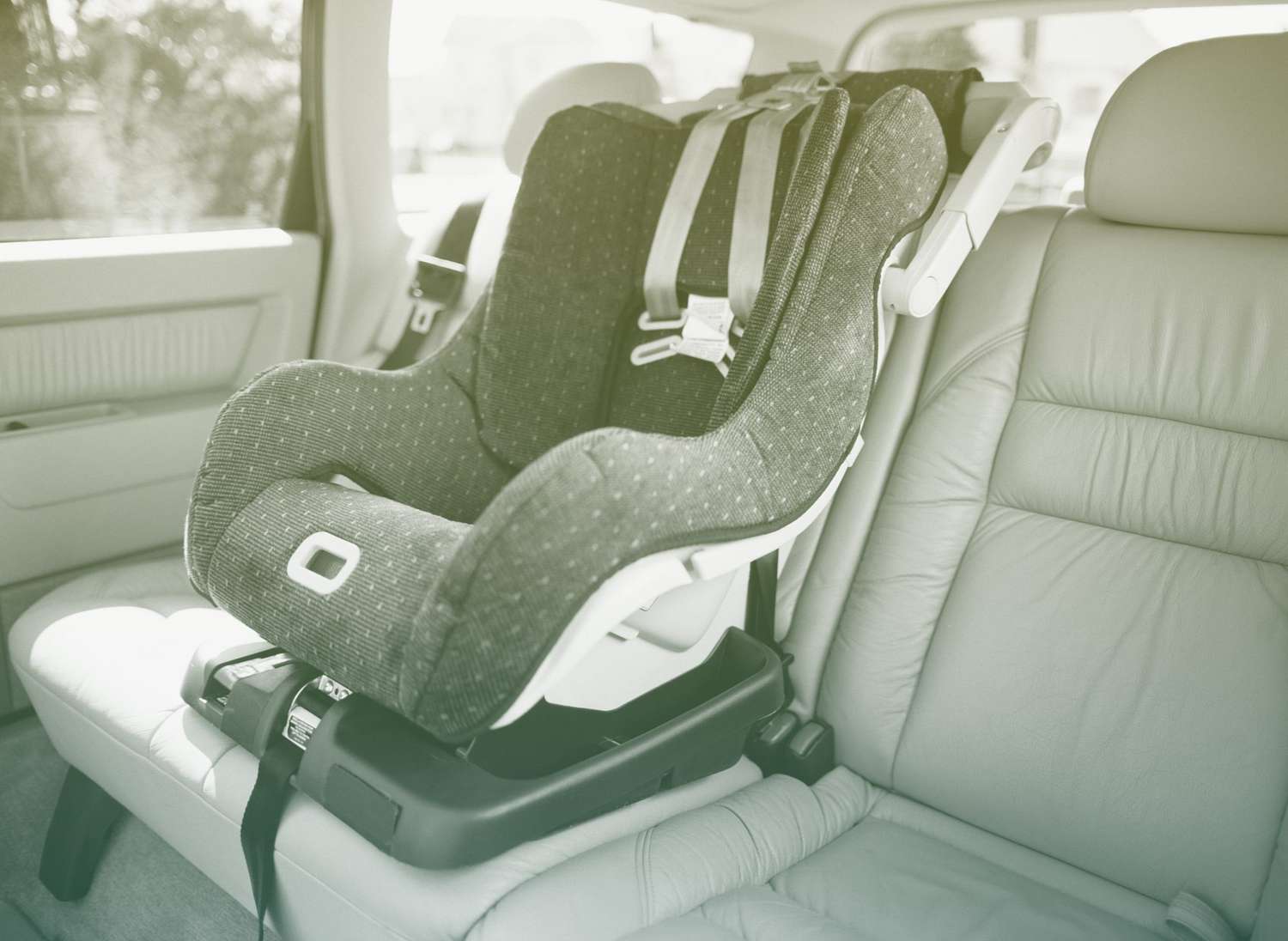 car seat attached to back seat of car