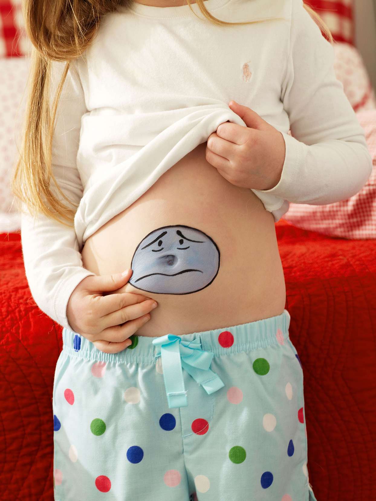 girl polka-dot pajamas sad face drawn tummy