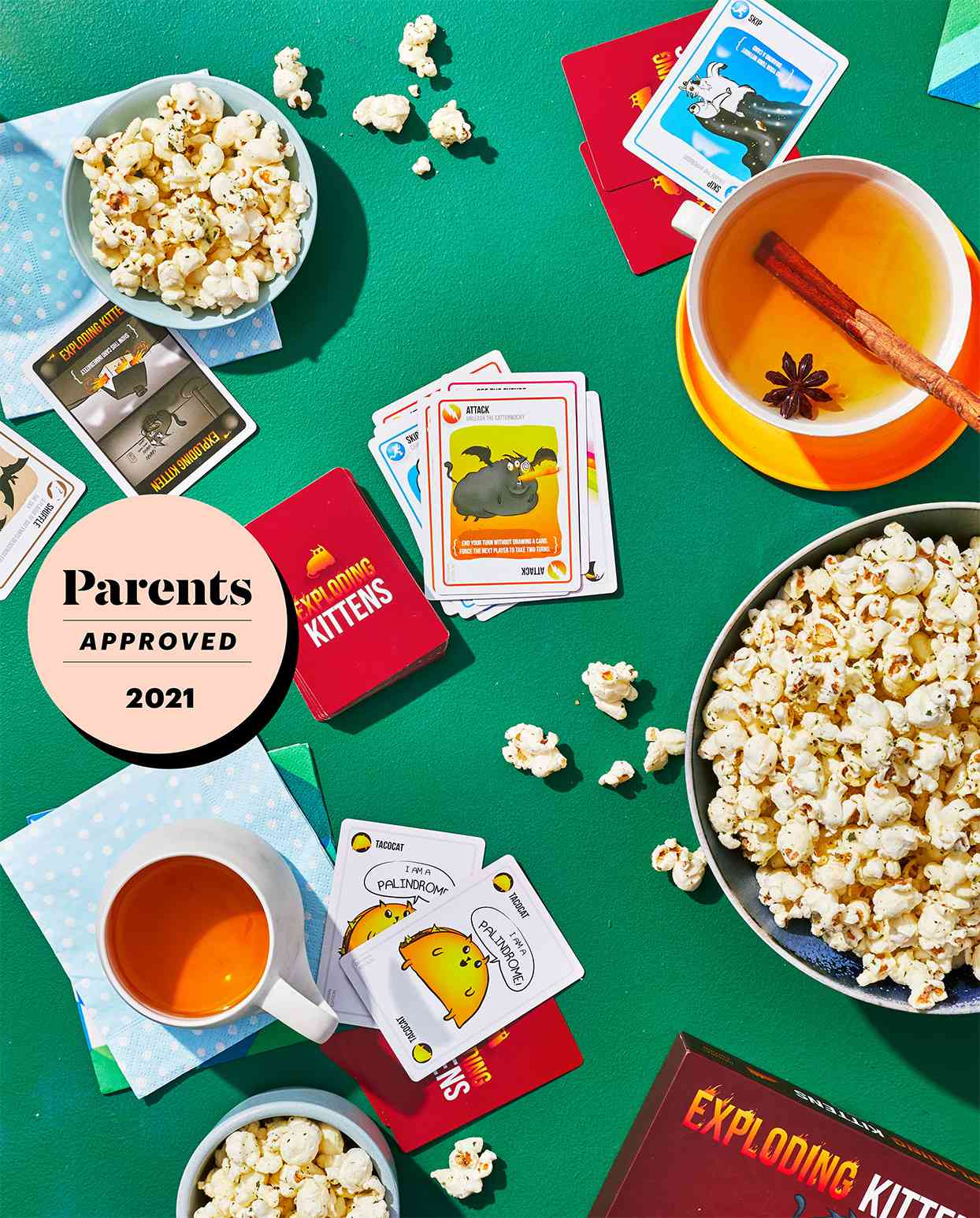 card games and popcorn on green table