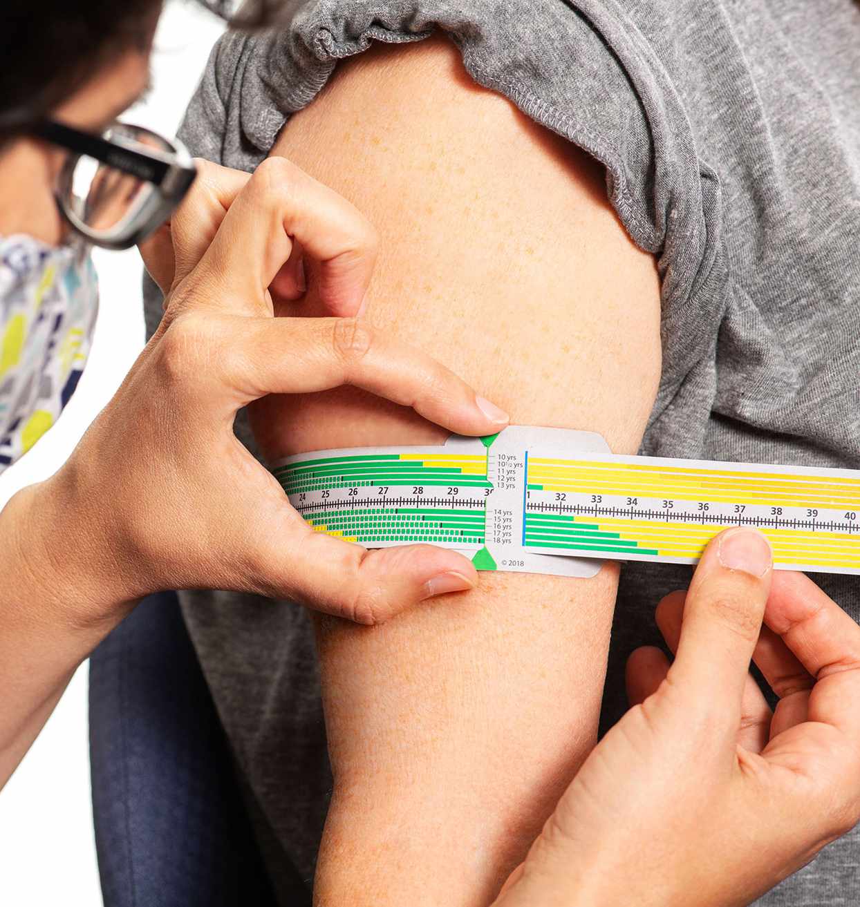 child getting measured for wellness check