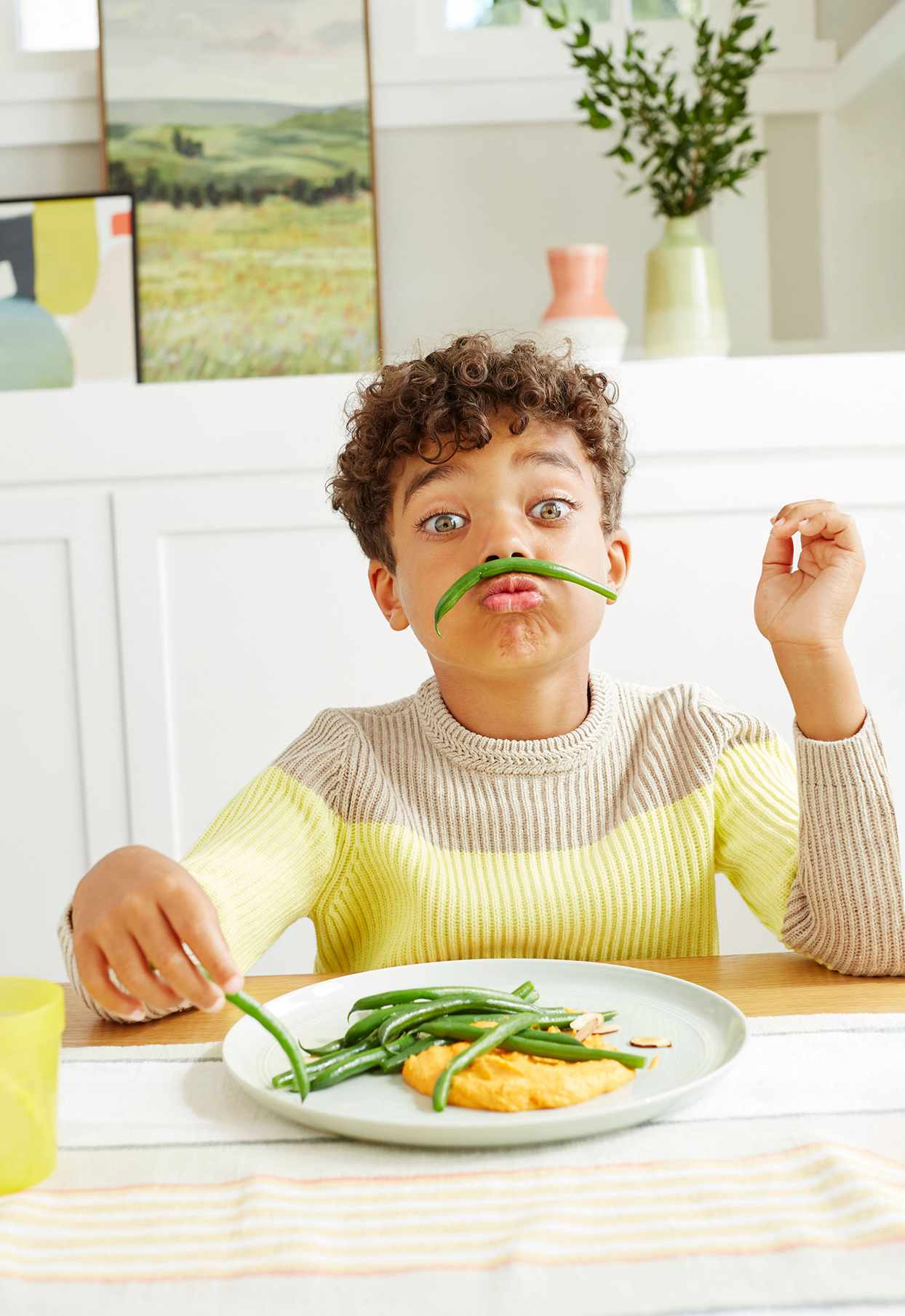 child playing with green beans