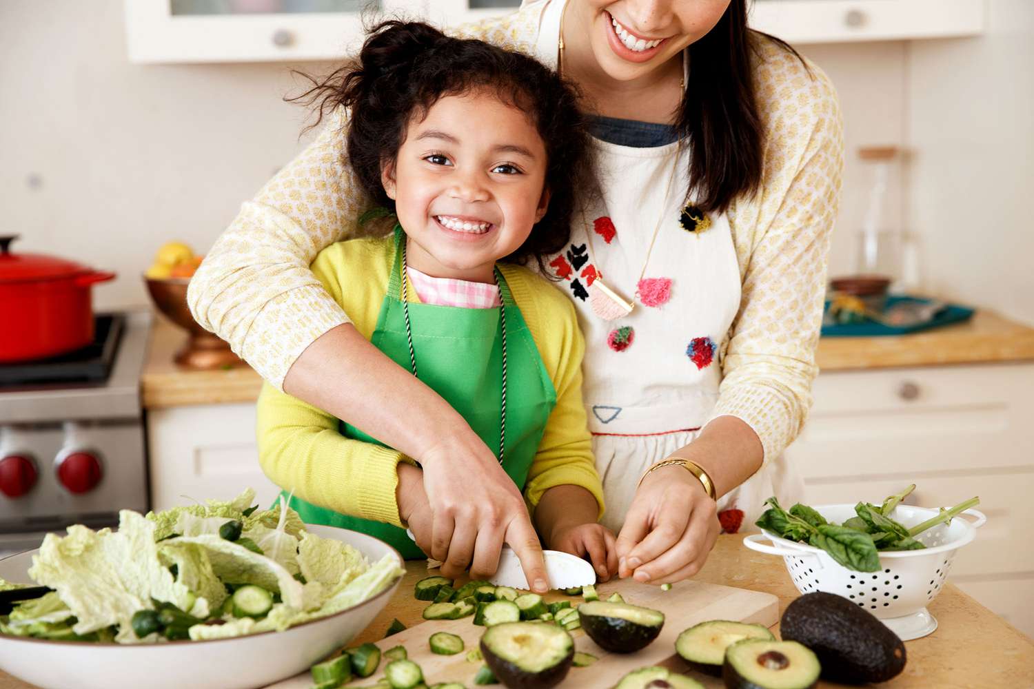 parent and child making a salad together