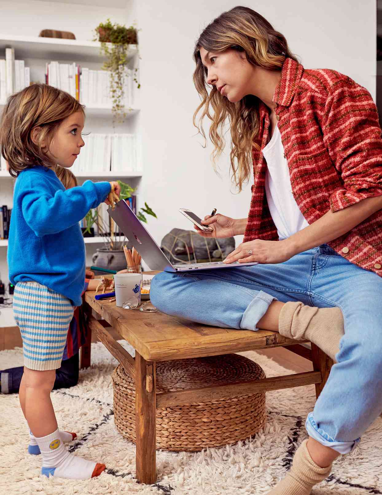 mom on laptop with small child