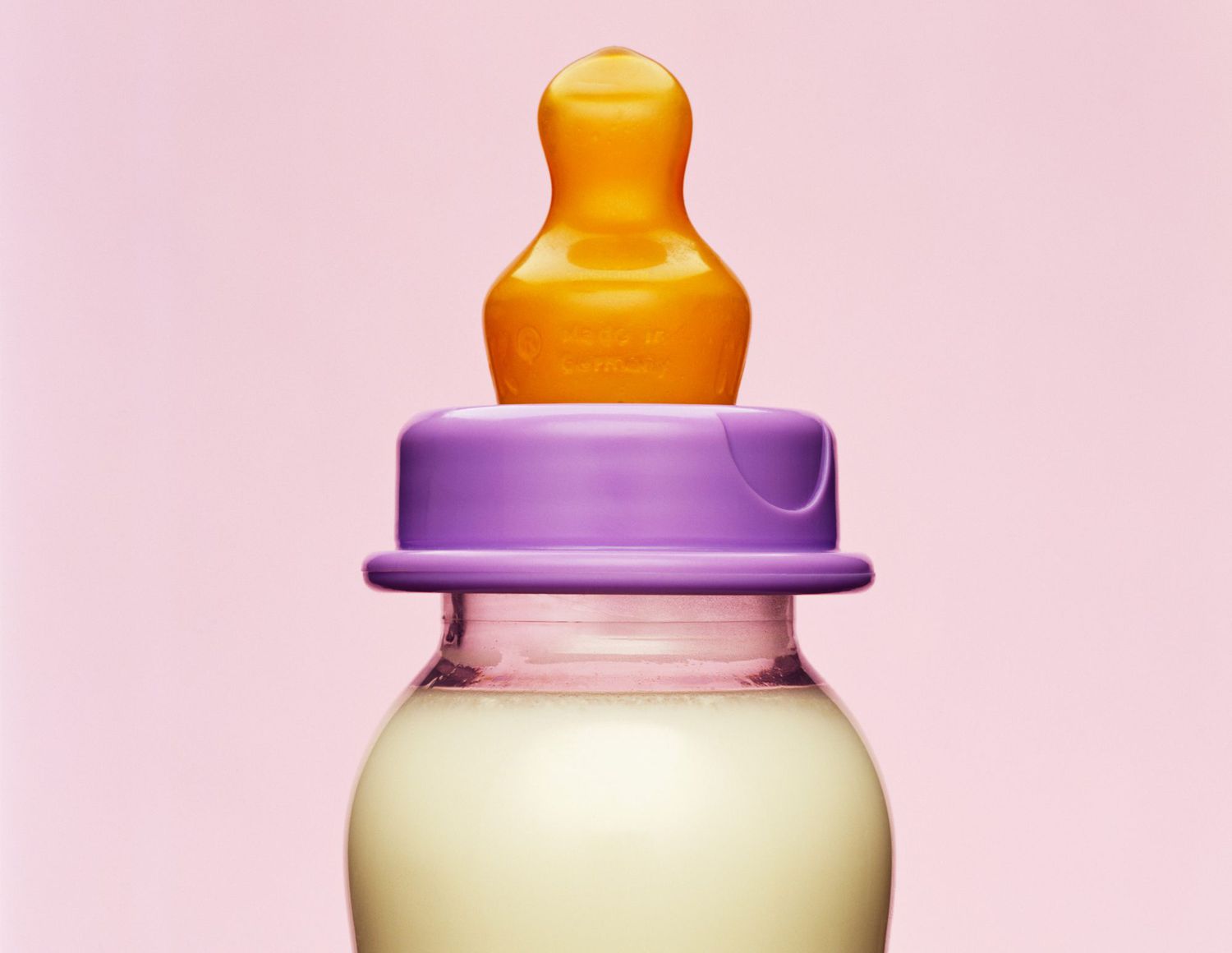 An image of a baby bottle with milk in it.