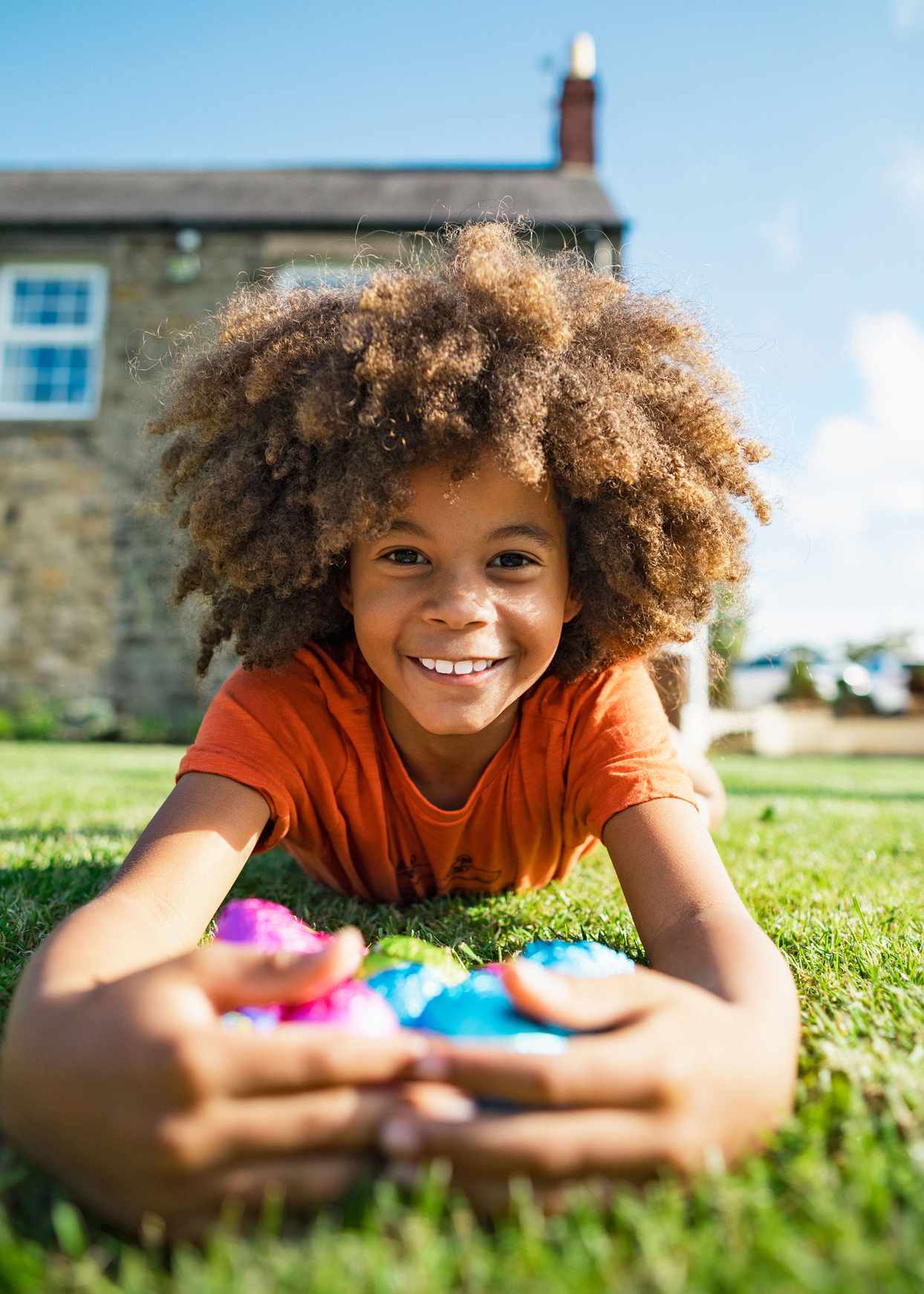 kid outside in grass with easter eggs