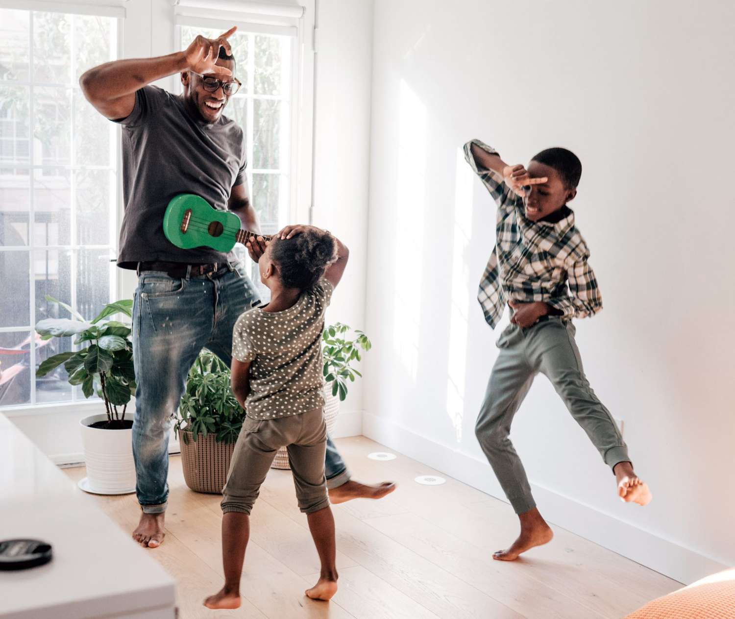 An image of a dad dancing with his children.