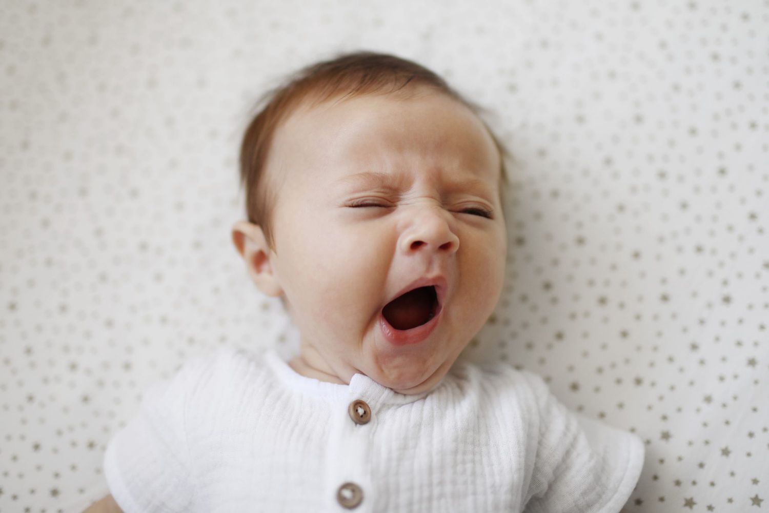An image of a baby yawning.