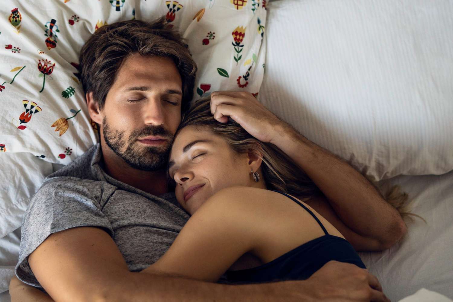 An image of a couple laying in bed.