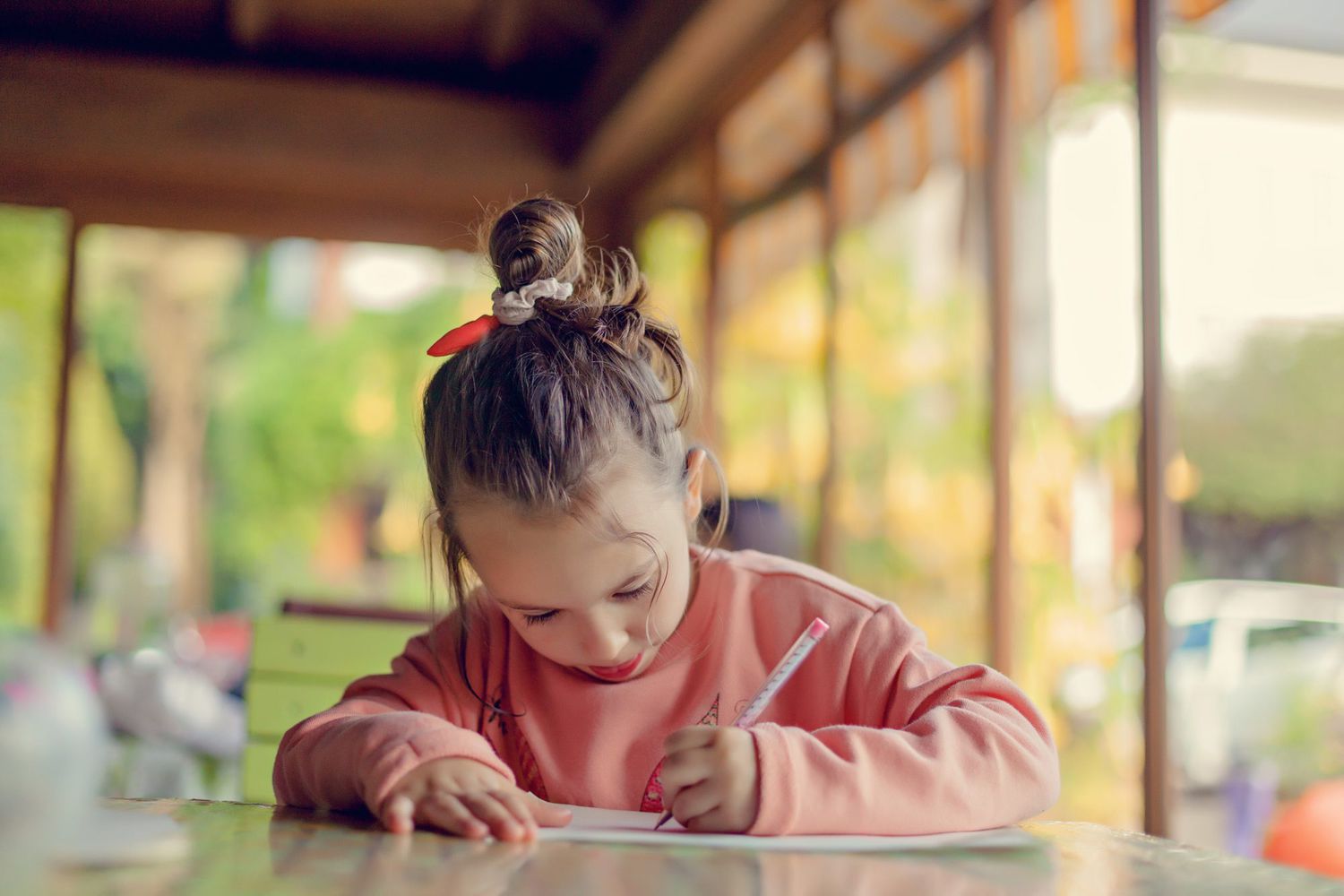 An image of a little girl writing.