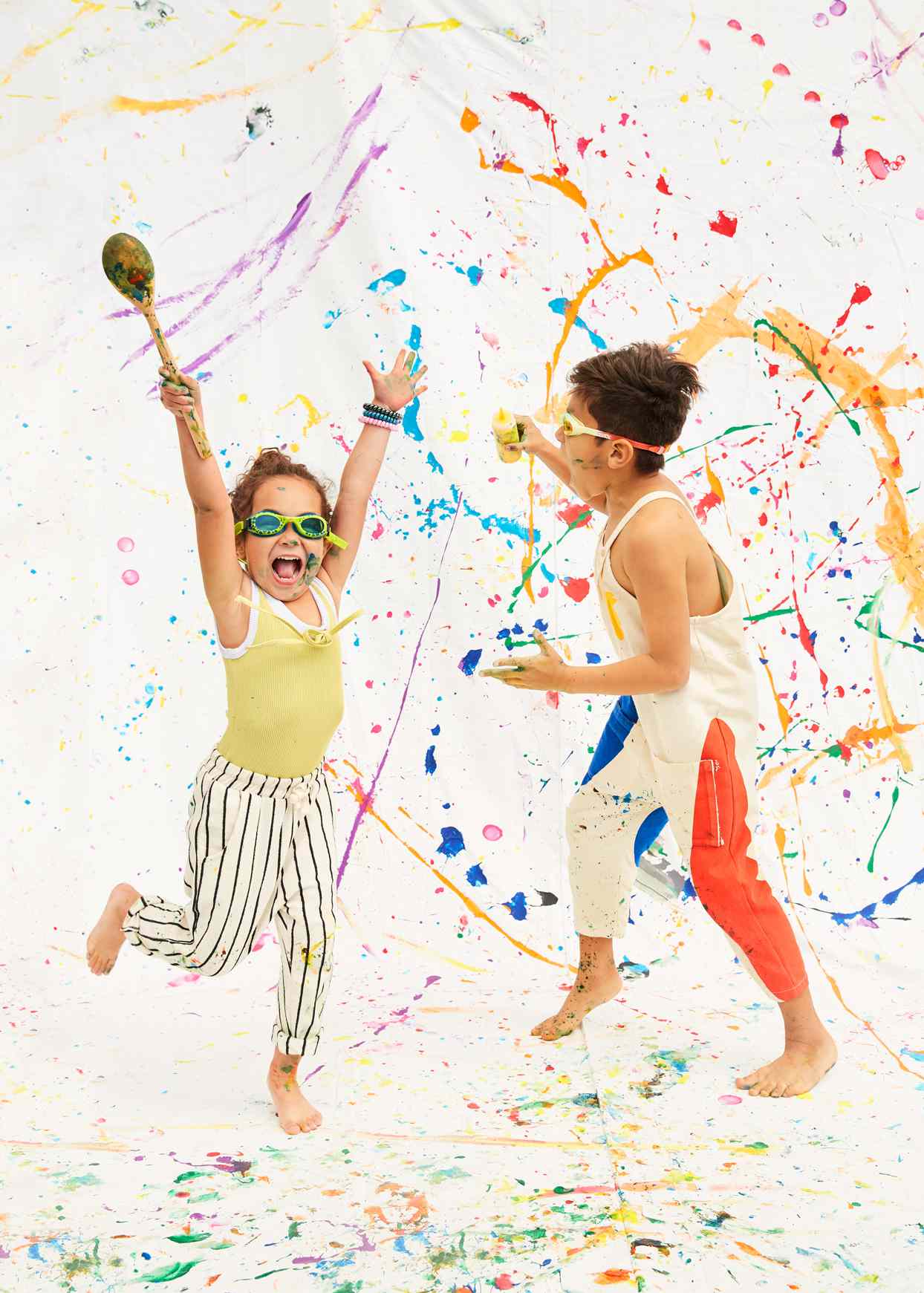 kids playing with paint on white canvas