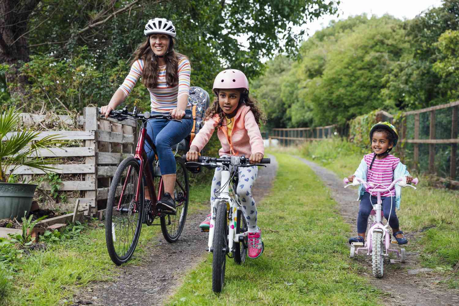 An image of a mom riding bikes with her daughter.