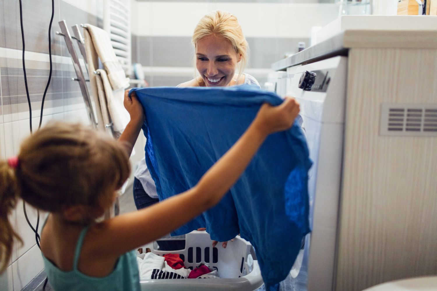 An image of a mother and daughter doing laundry.