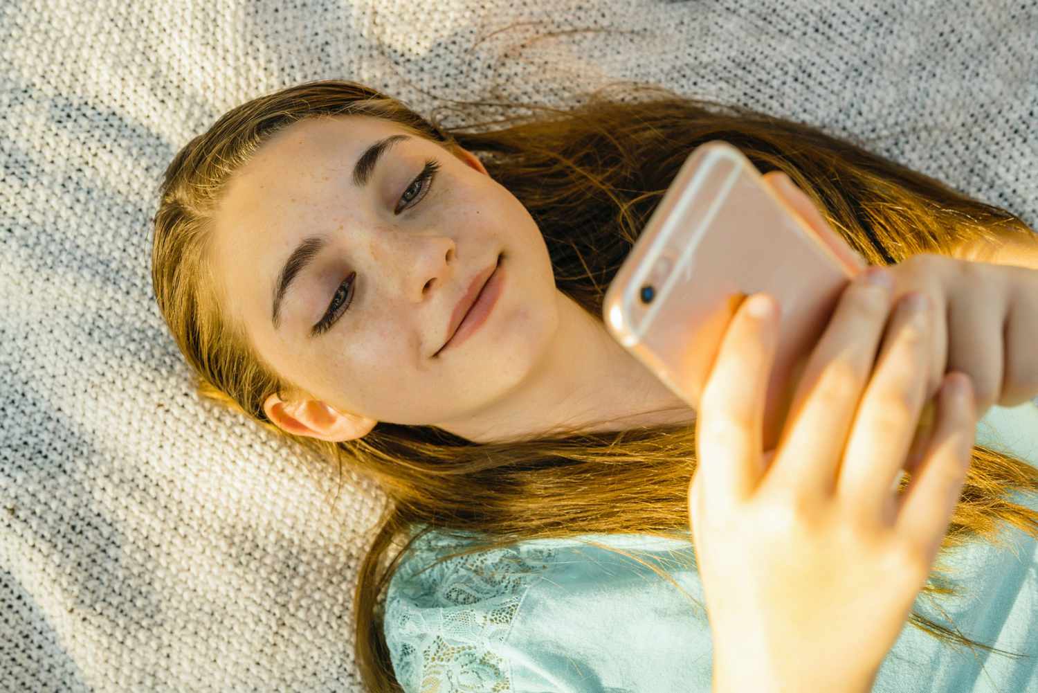 An image of a girl on her phone.