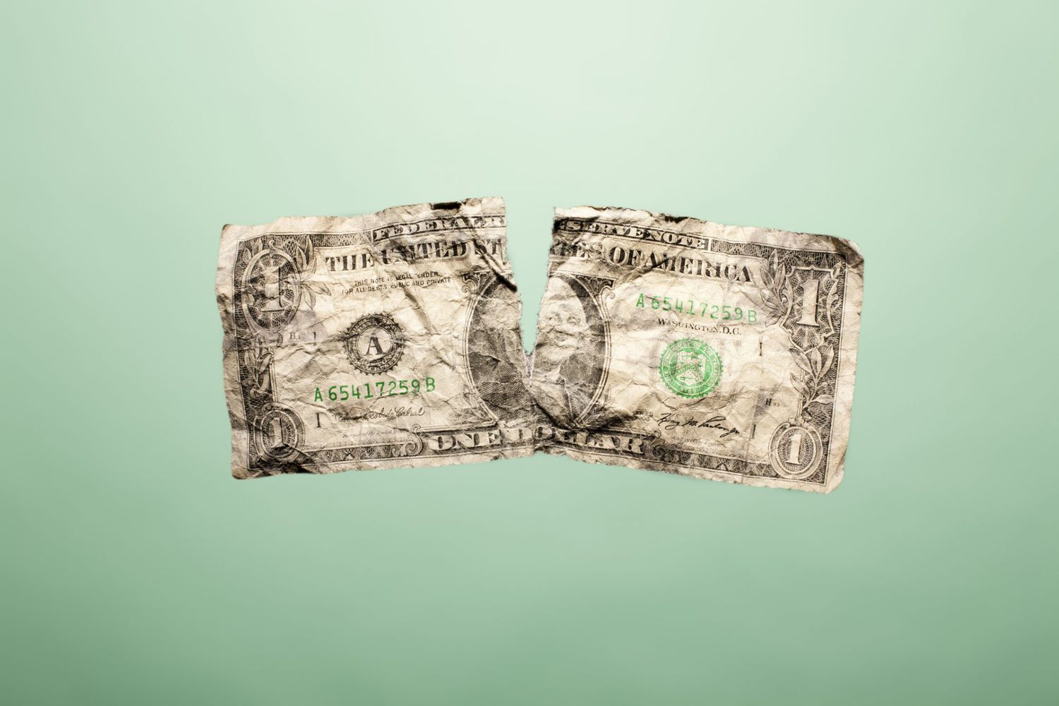 An image of a torn dollar bill.