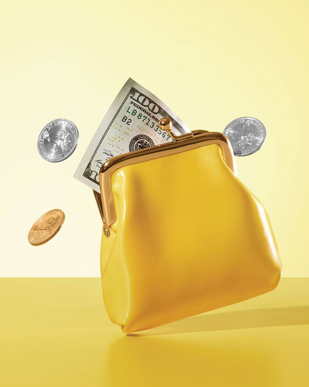 yellow coin purse with cash and coins coming out of it