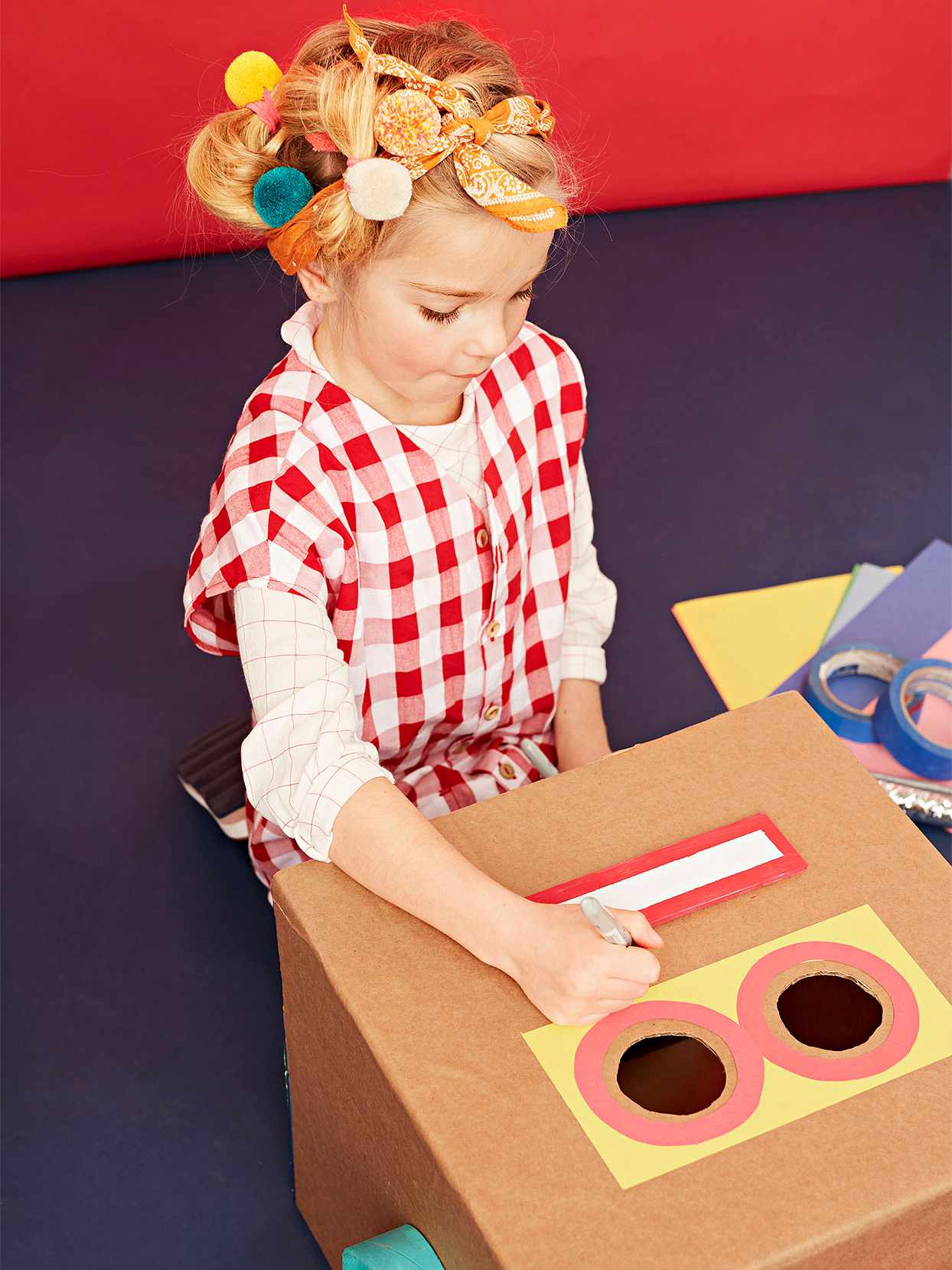 girl red gingham creating painted robot cardboard box