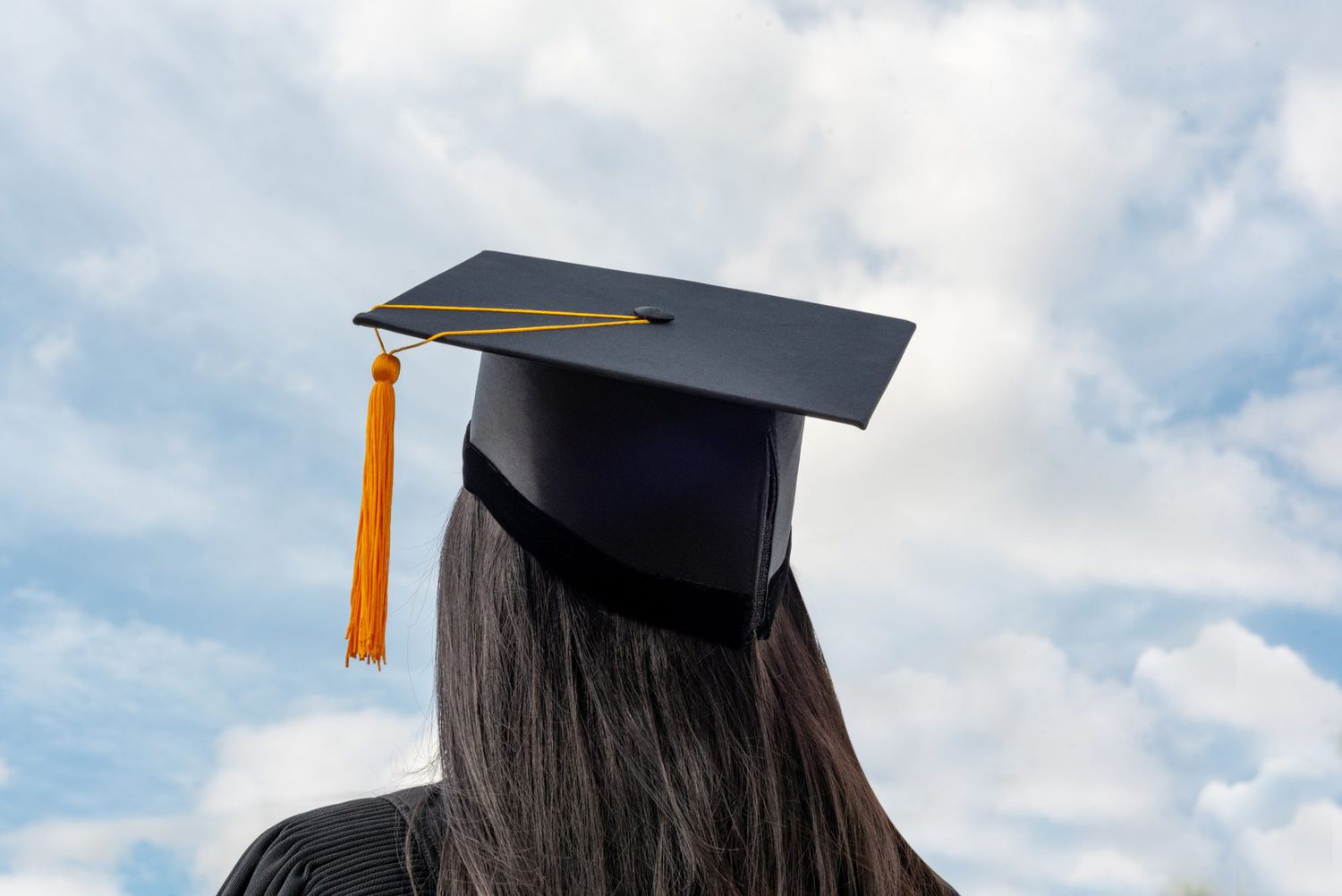 An image of a girl in a graduation cap and gown.