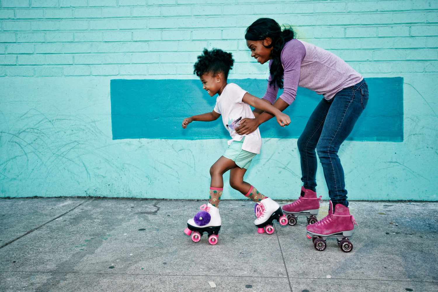 An image of a mom and daughter roller skating.