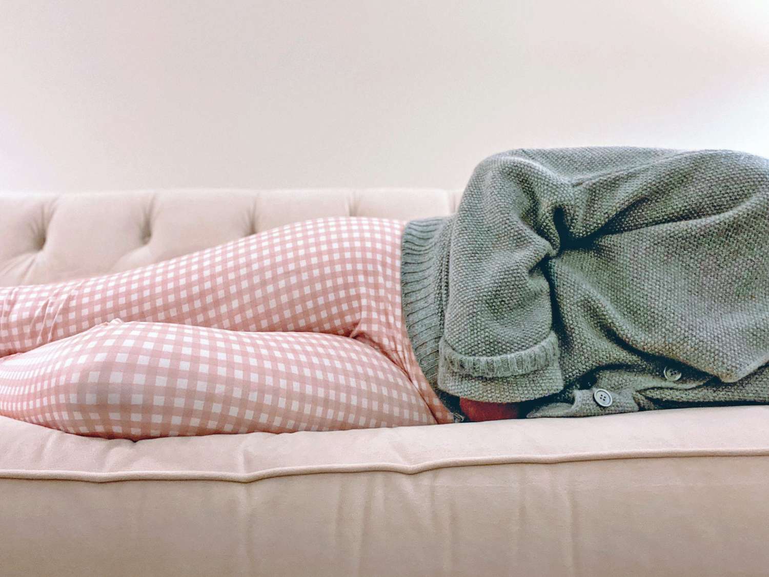 An image of a woman laying on a couch.