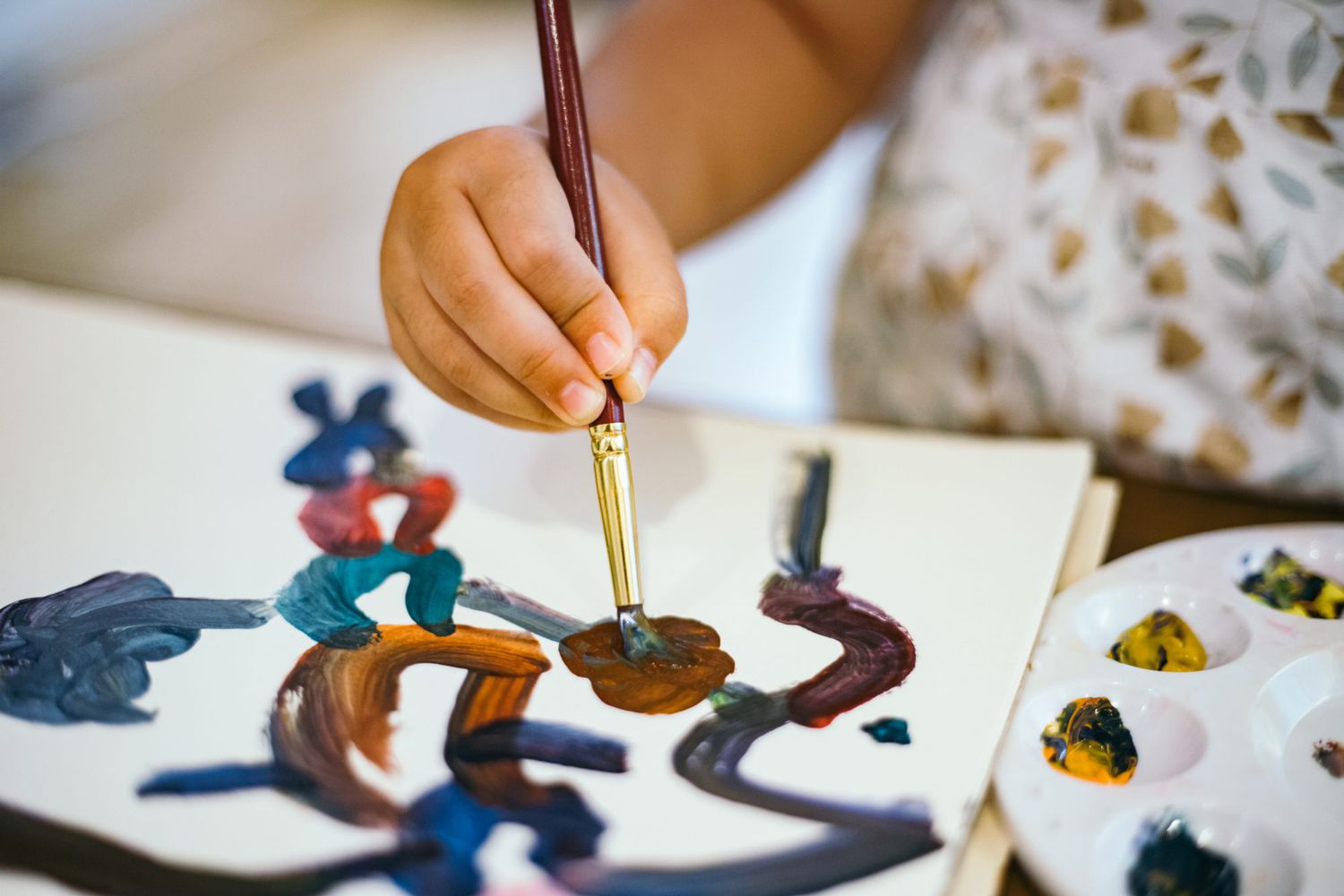 An image of a toddler painting.