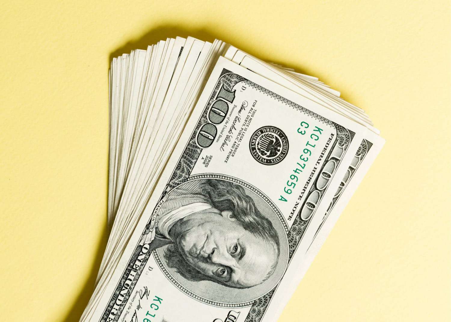 An image of money on a yellow background.