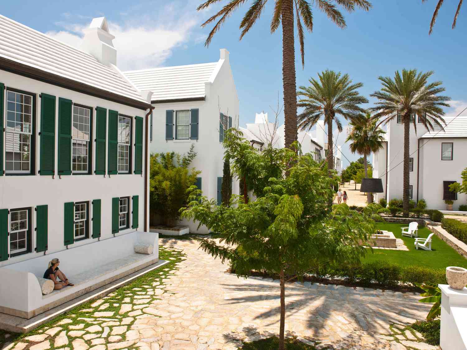 white buildings with green shutters alys beach florida