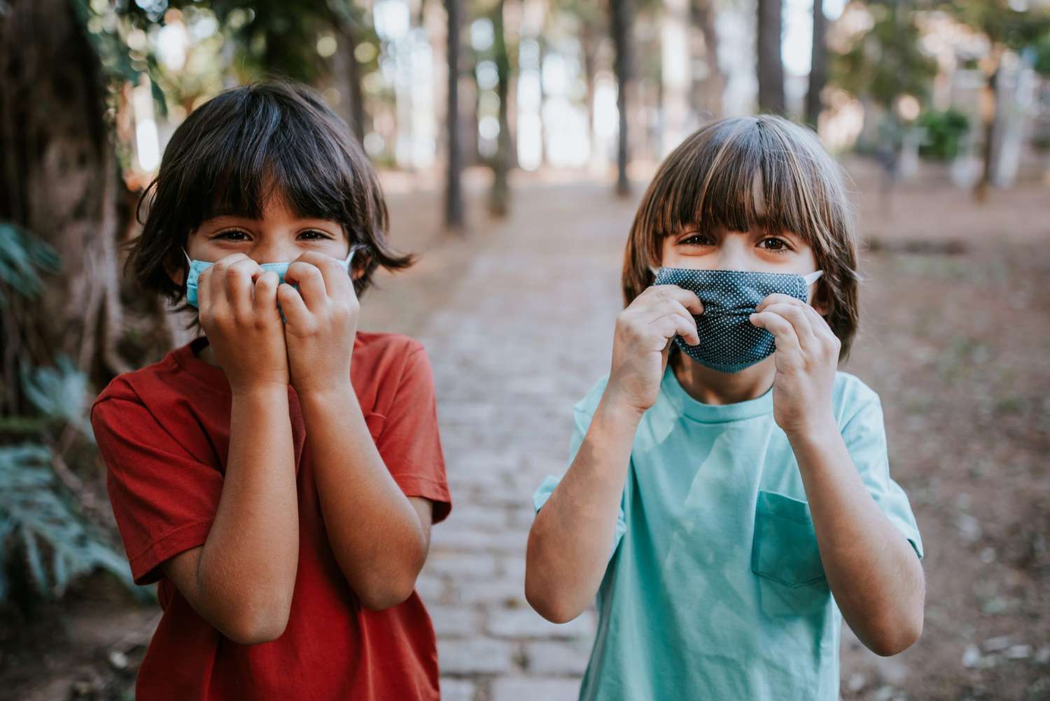 An image of two boys wearing face masks.