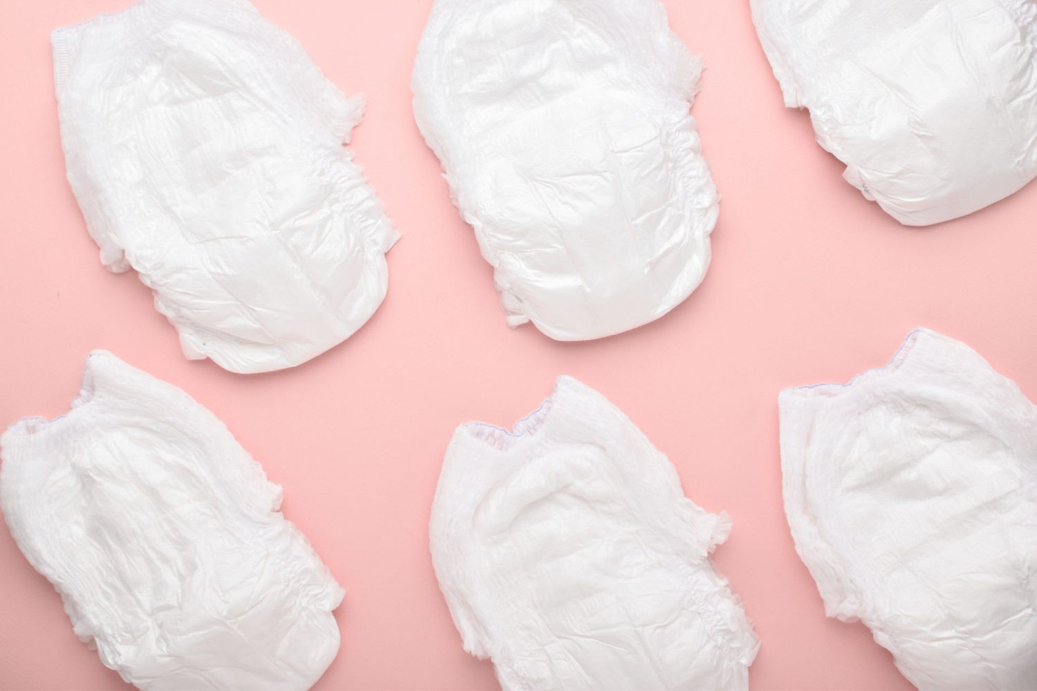 An image of diapers on a pink background.