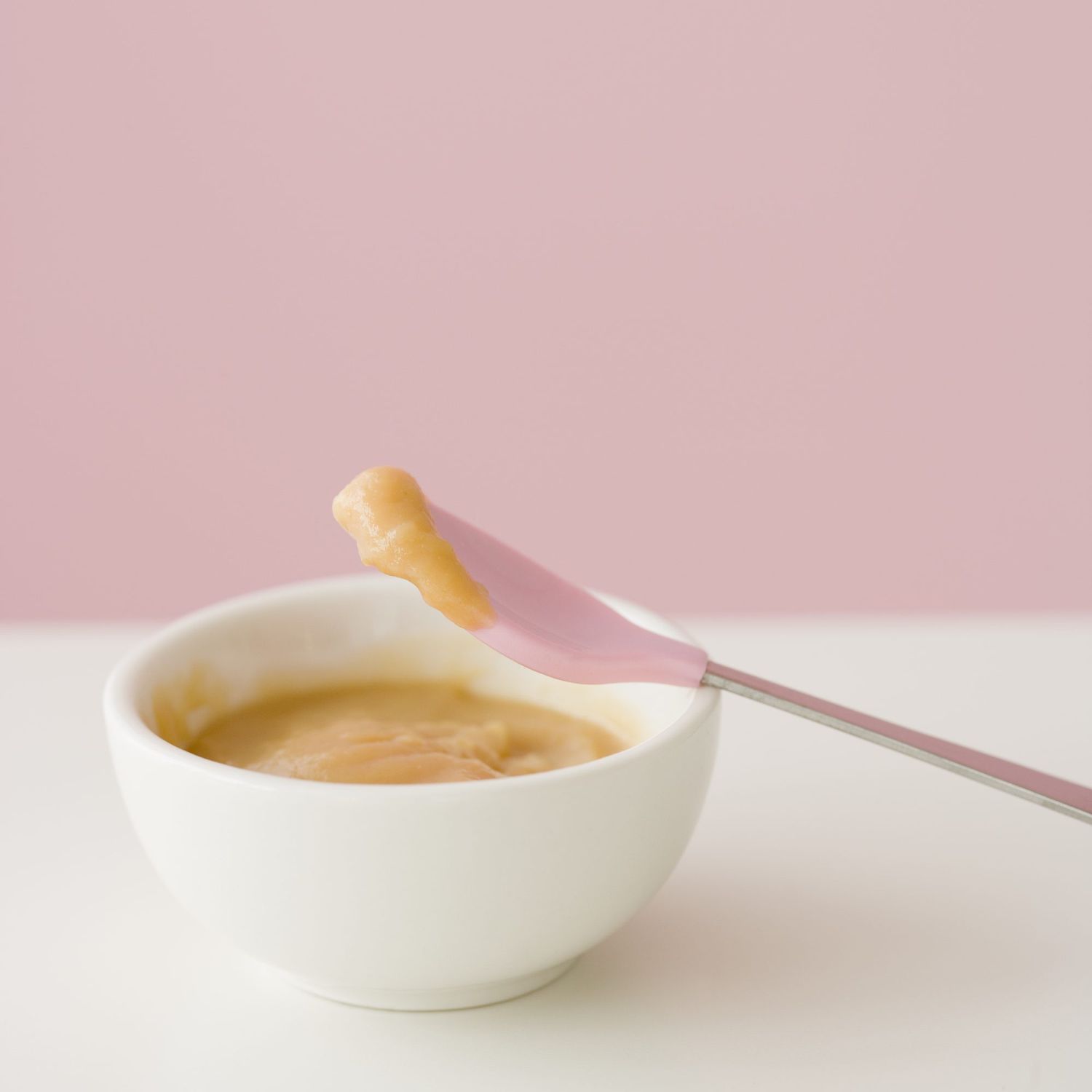 An image of a close up of baby food and spoon.