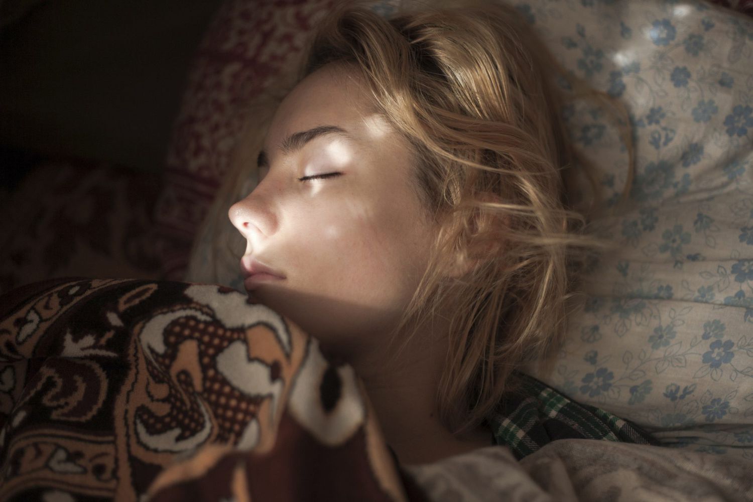 An image of a woman sleeping in bed.
