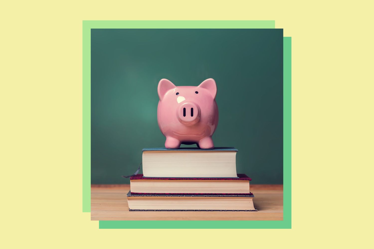 An image of a piggy bank on top of books.