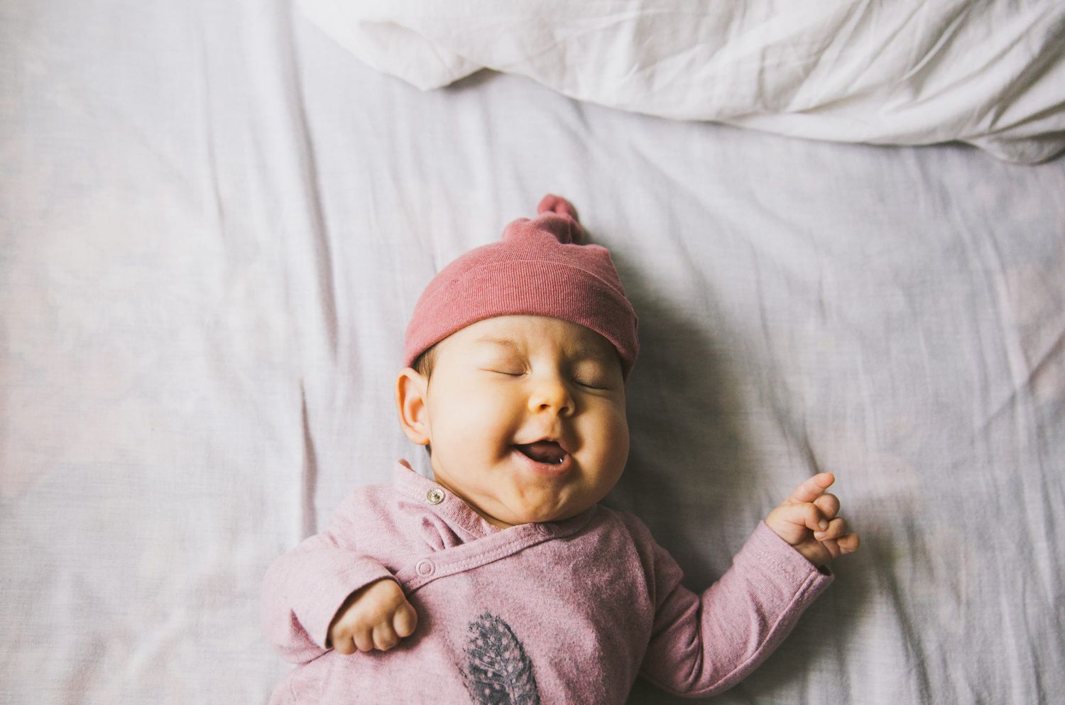An image of a baby laughing.