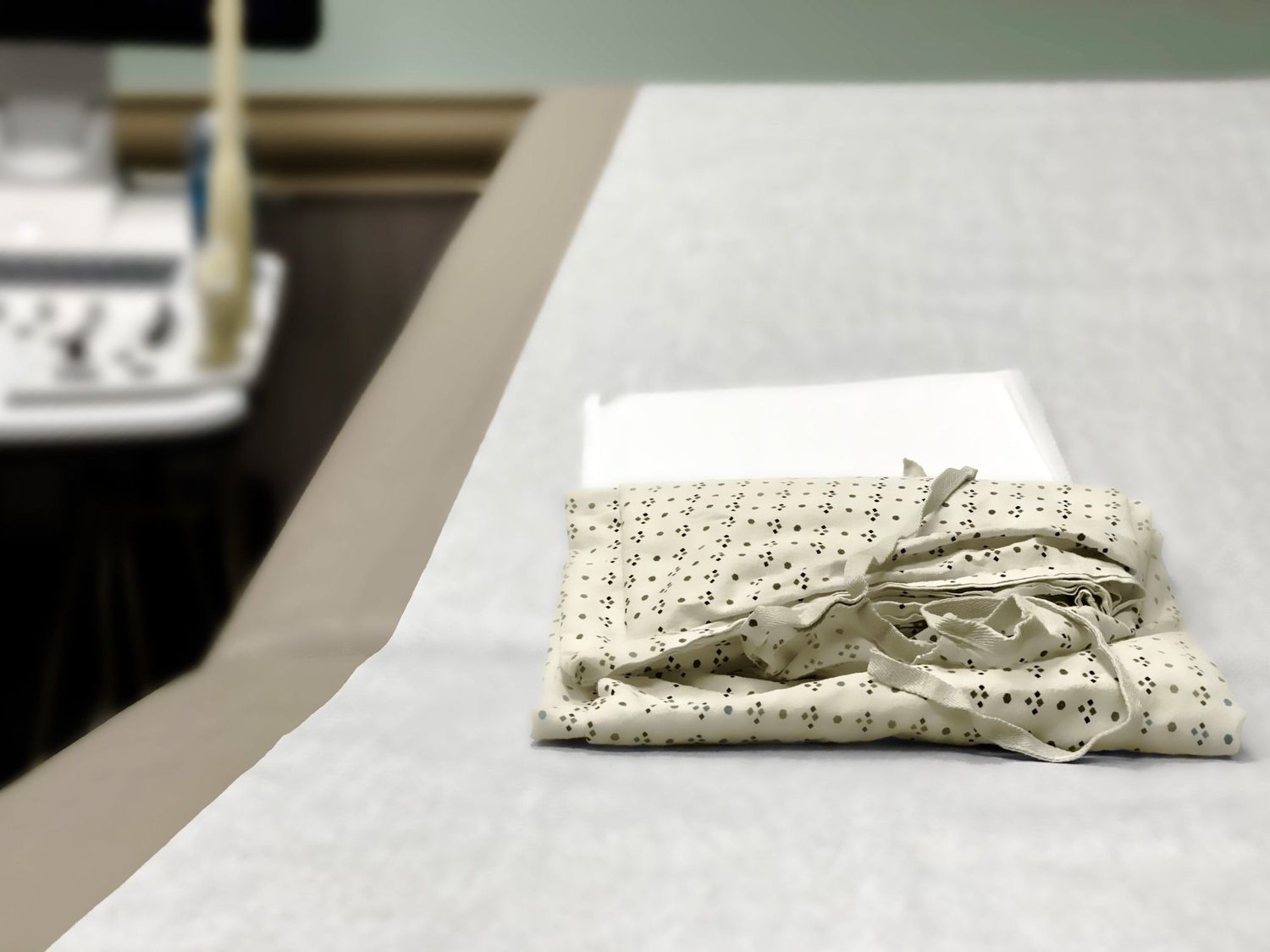 An image of a medical examination table in a gynecologist office.