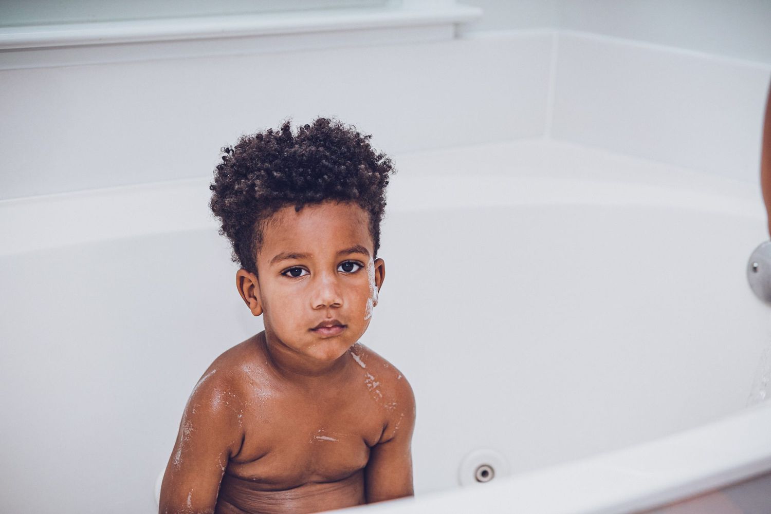 An image of Coleman in the bath tub during wash day.