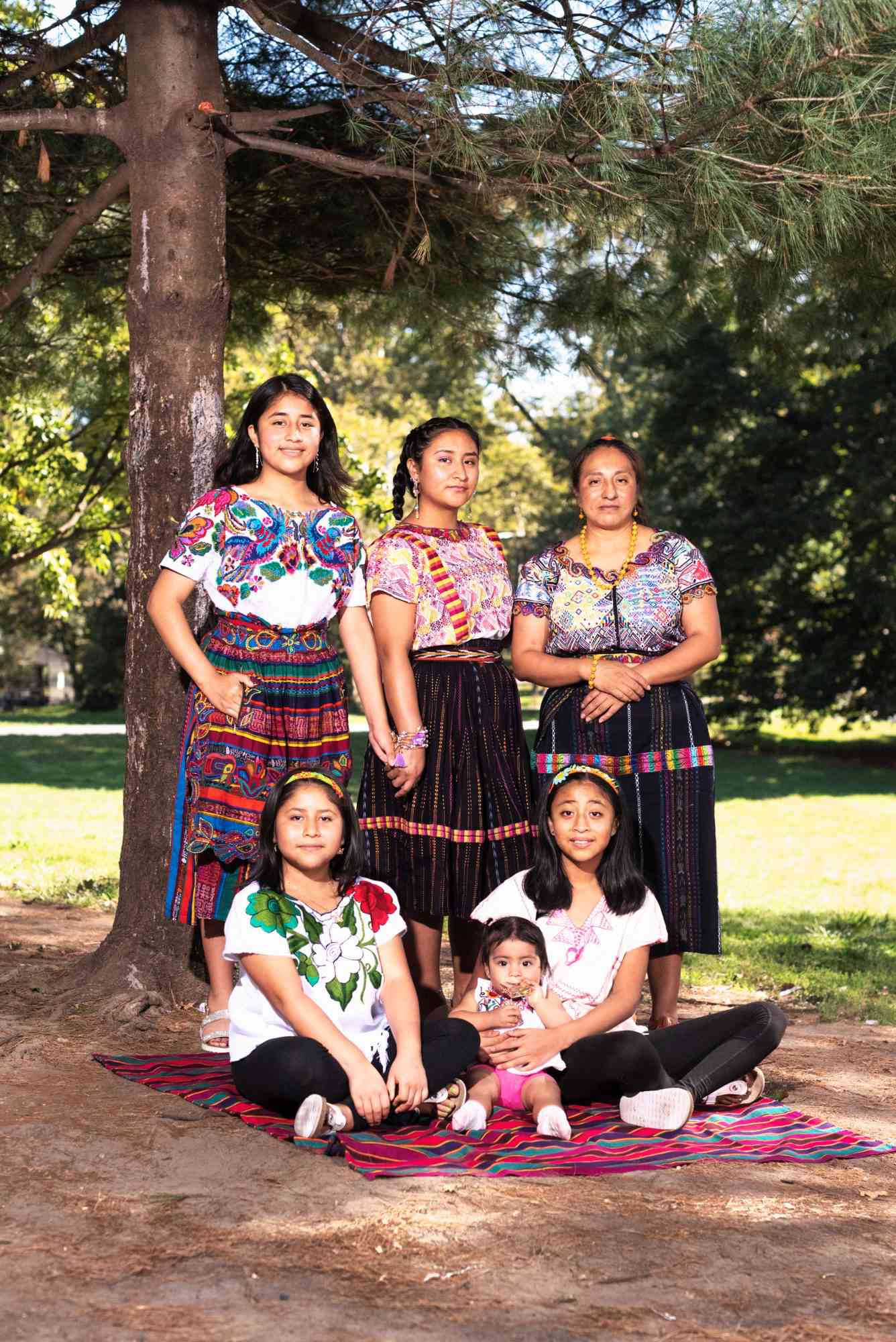 An image of Martina's* family wearing traditional hand-crafted Guatemalan clothes.