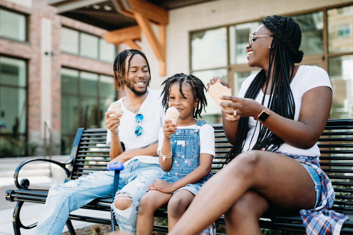Family Enjoying Ice Cream on a bench in the city