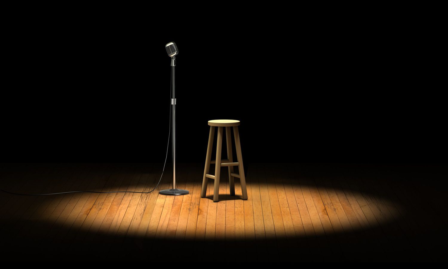 Dark stage with a microphone and empty stool with spot light on them