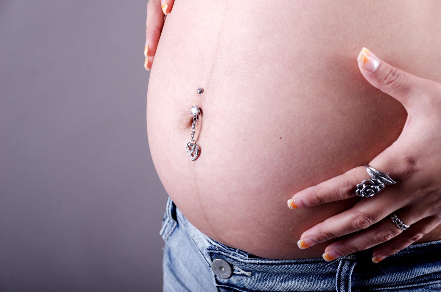 pregnant belly with piercing