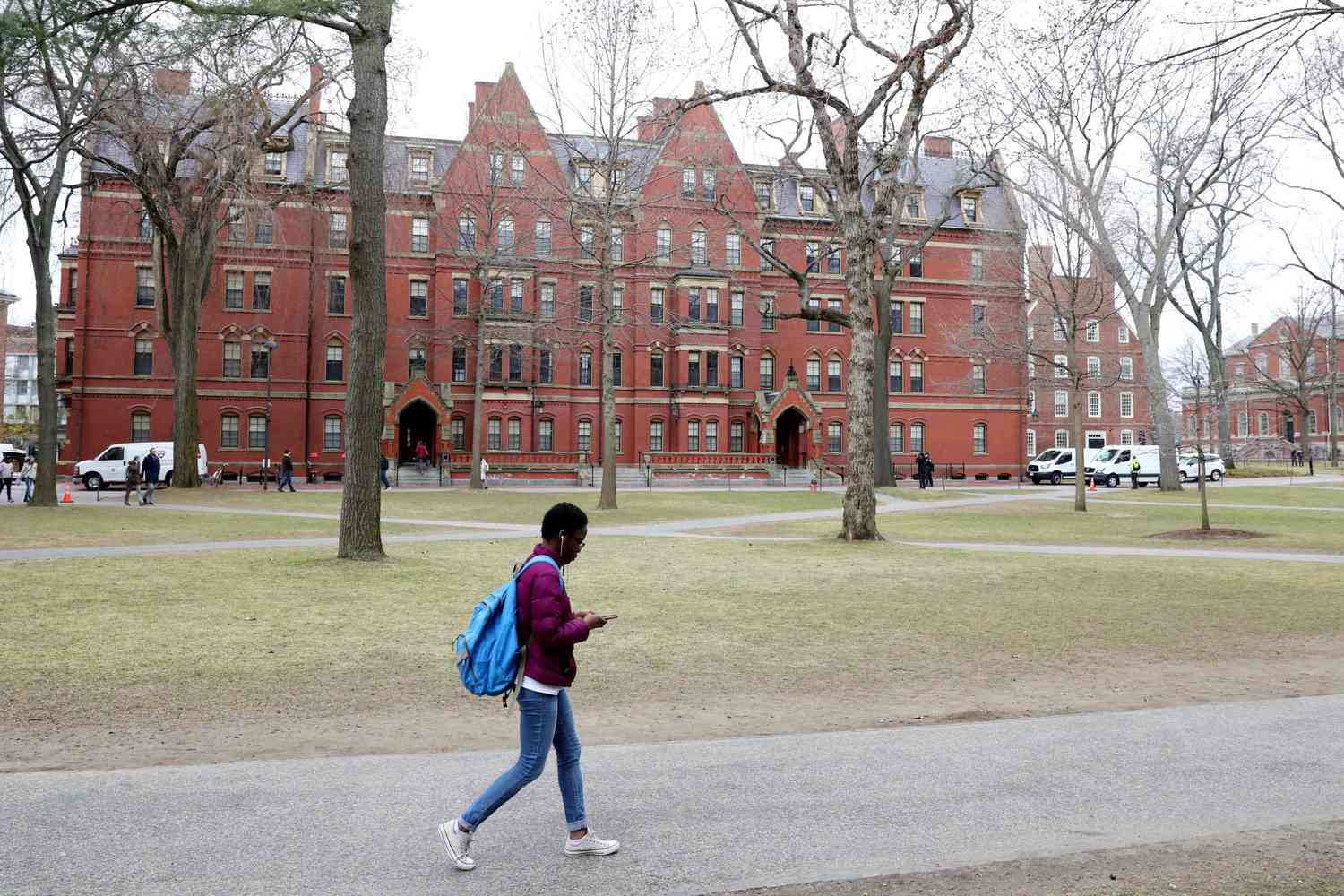 A Black student walks through Harvard Yard on the campus of Harvard University