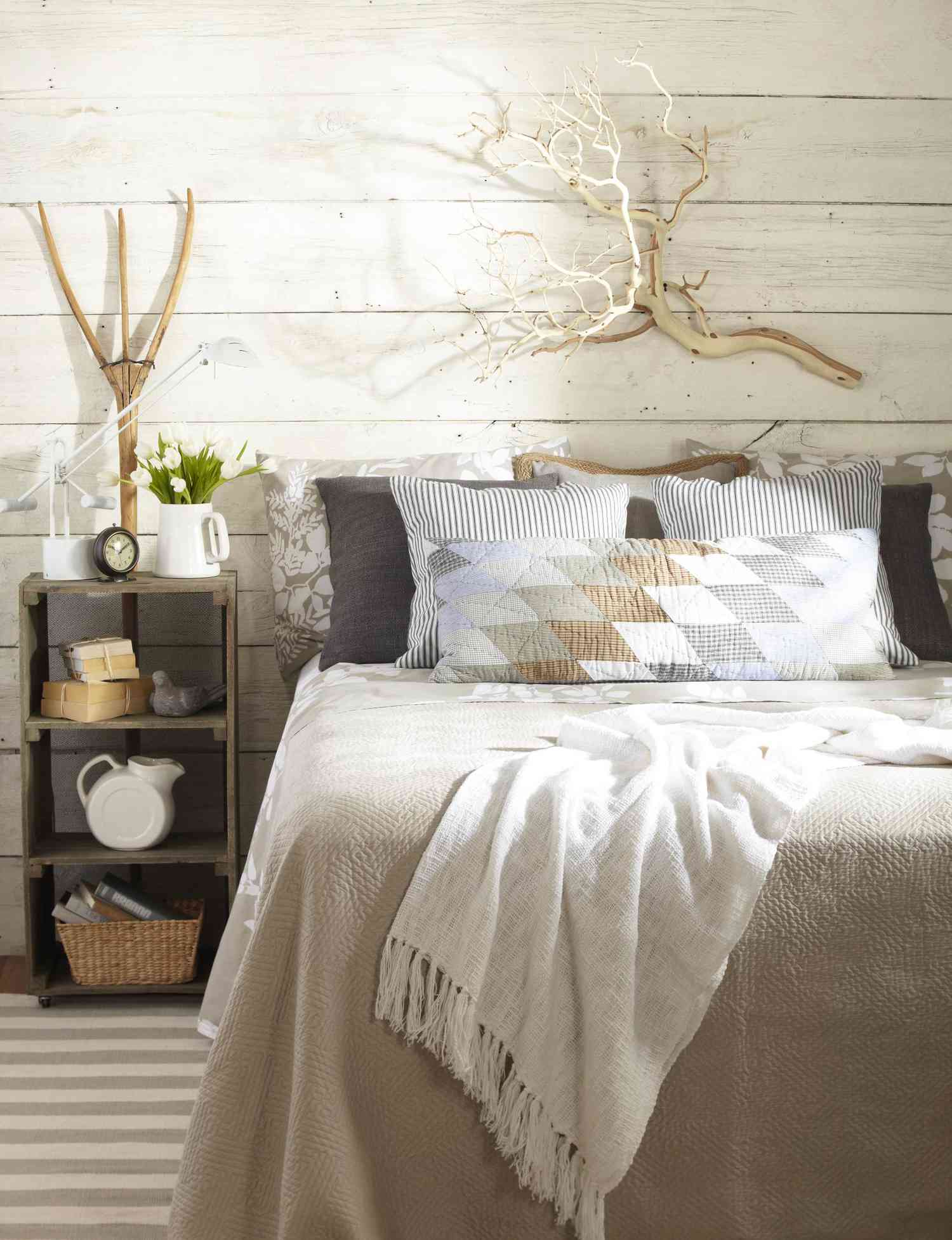 Quilts and ticked pillows on silk, modern, contemporary bed.