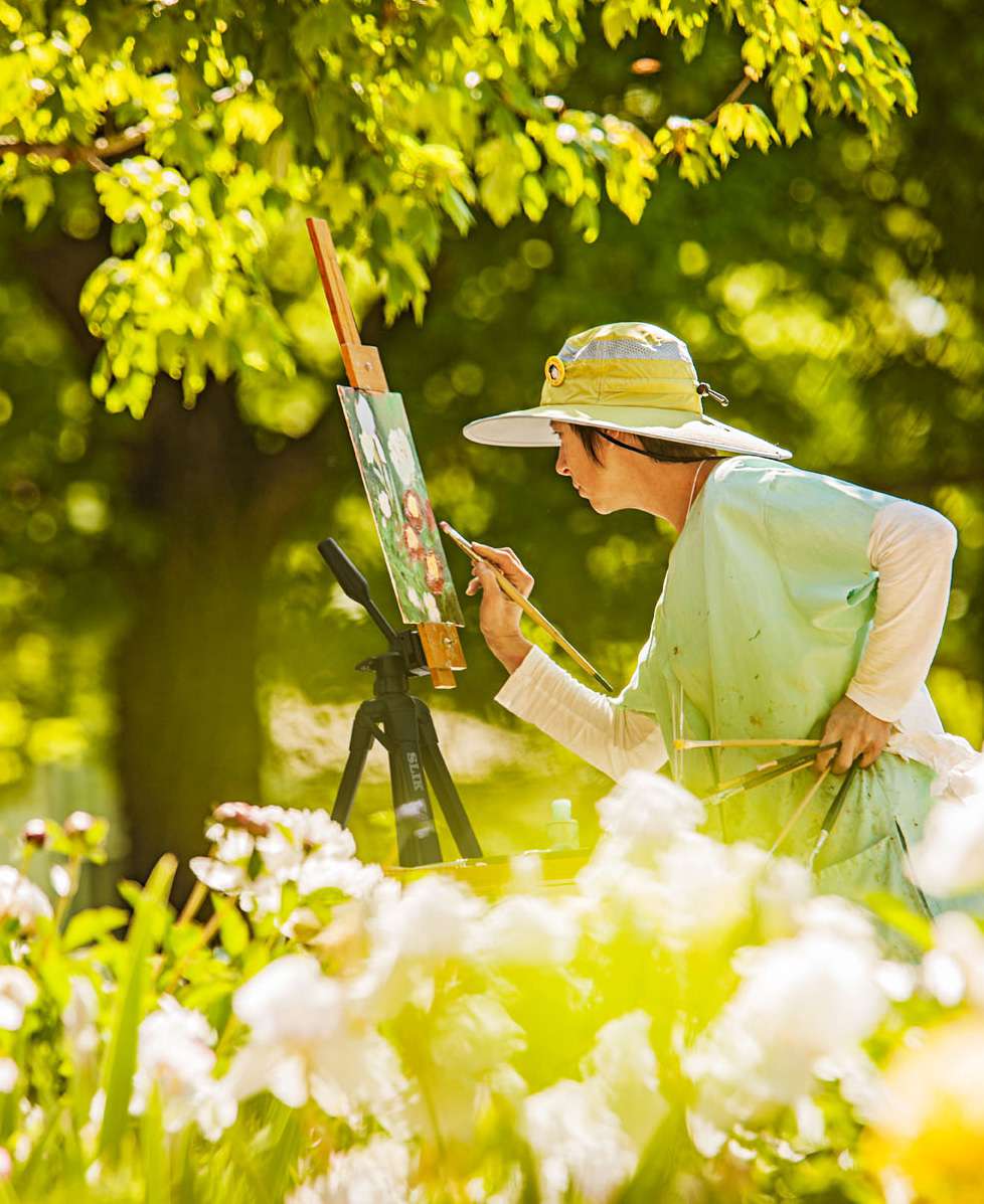 Artist Linda Volz captures flowers on canvas during the annual plein air (open air) art festival in New Harmony, Indiana.