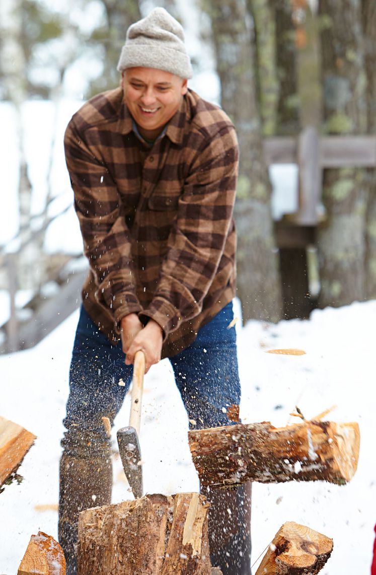 Aaron harvests wood for the stove (and, sometimes, for his artwork) on the 150-acre property