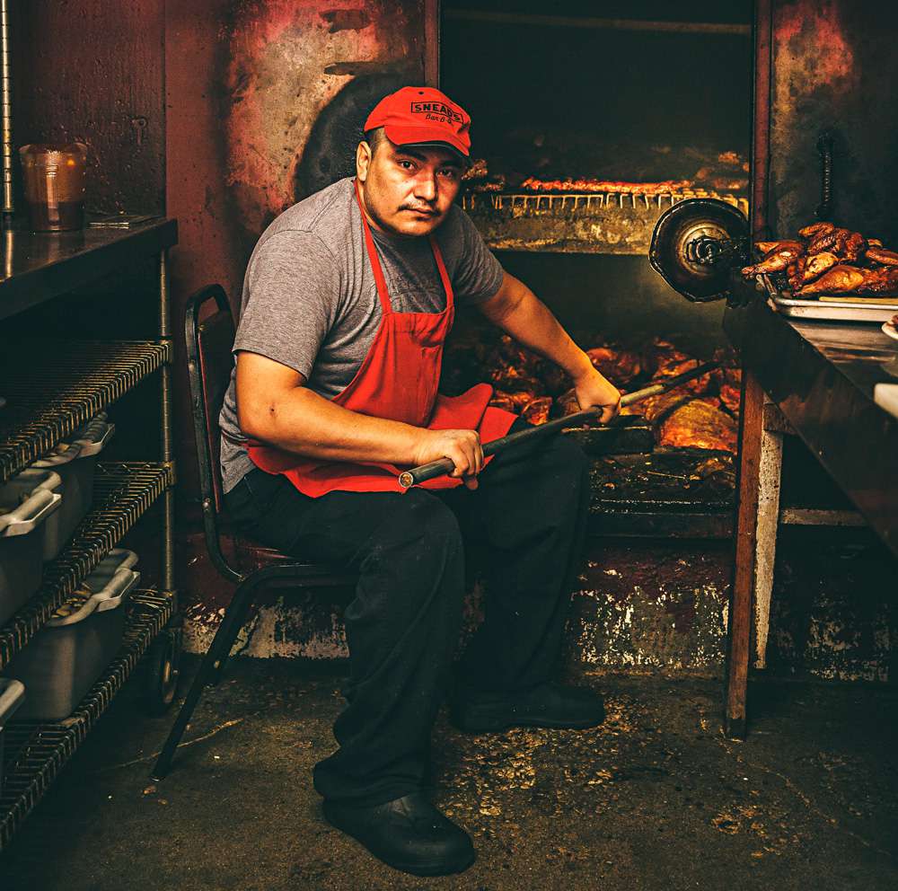 Gumaro tends ribs at Snead's Bar-B-Que's 59-year-old smoke pit in Belton where generations of pit masters have learned the subtleties of keeping the pit's heat perfect through varying temperatures, humidity and wind.