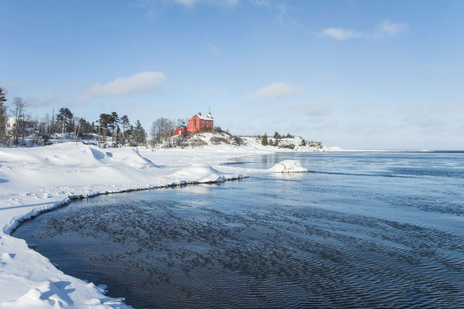 Marquette Lighthouse on frozen Lake Superior at Marquette, Michigan.