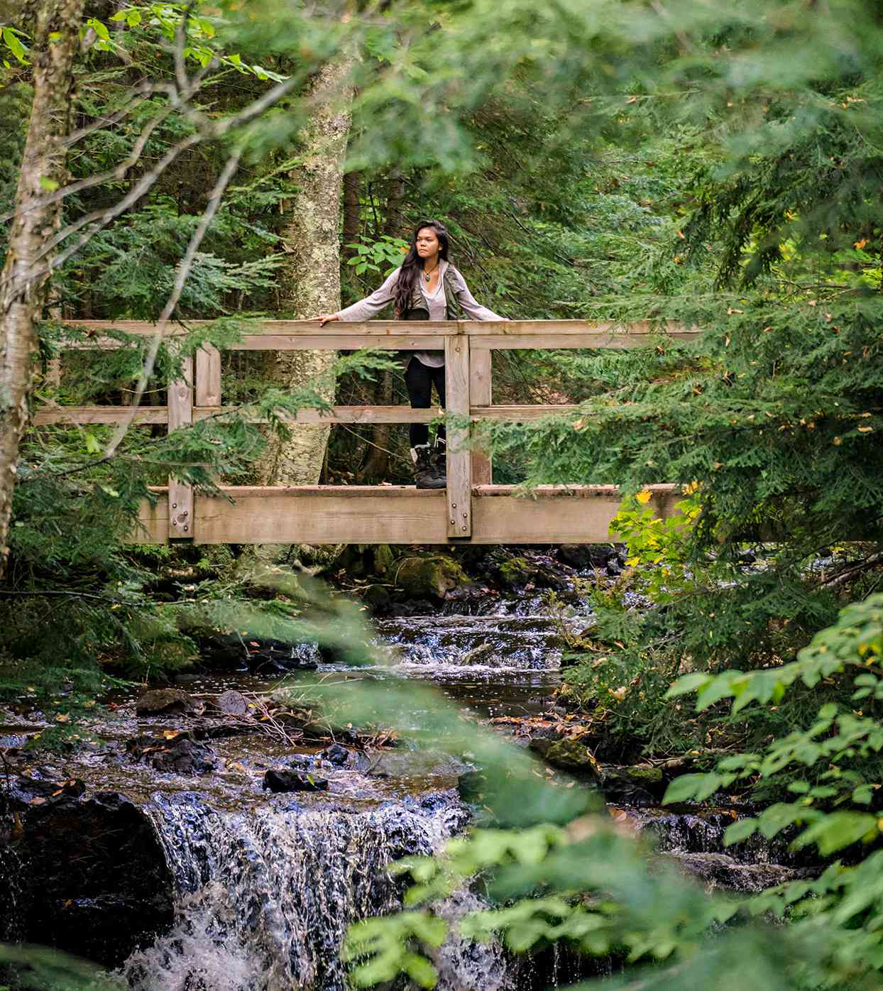 woman bridge forest stream pictured rocks national lakeshore michigan upper peninsula