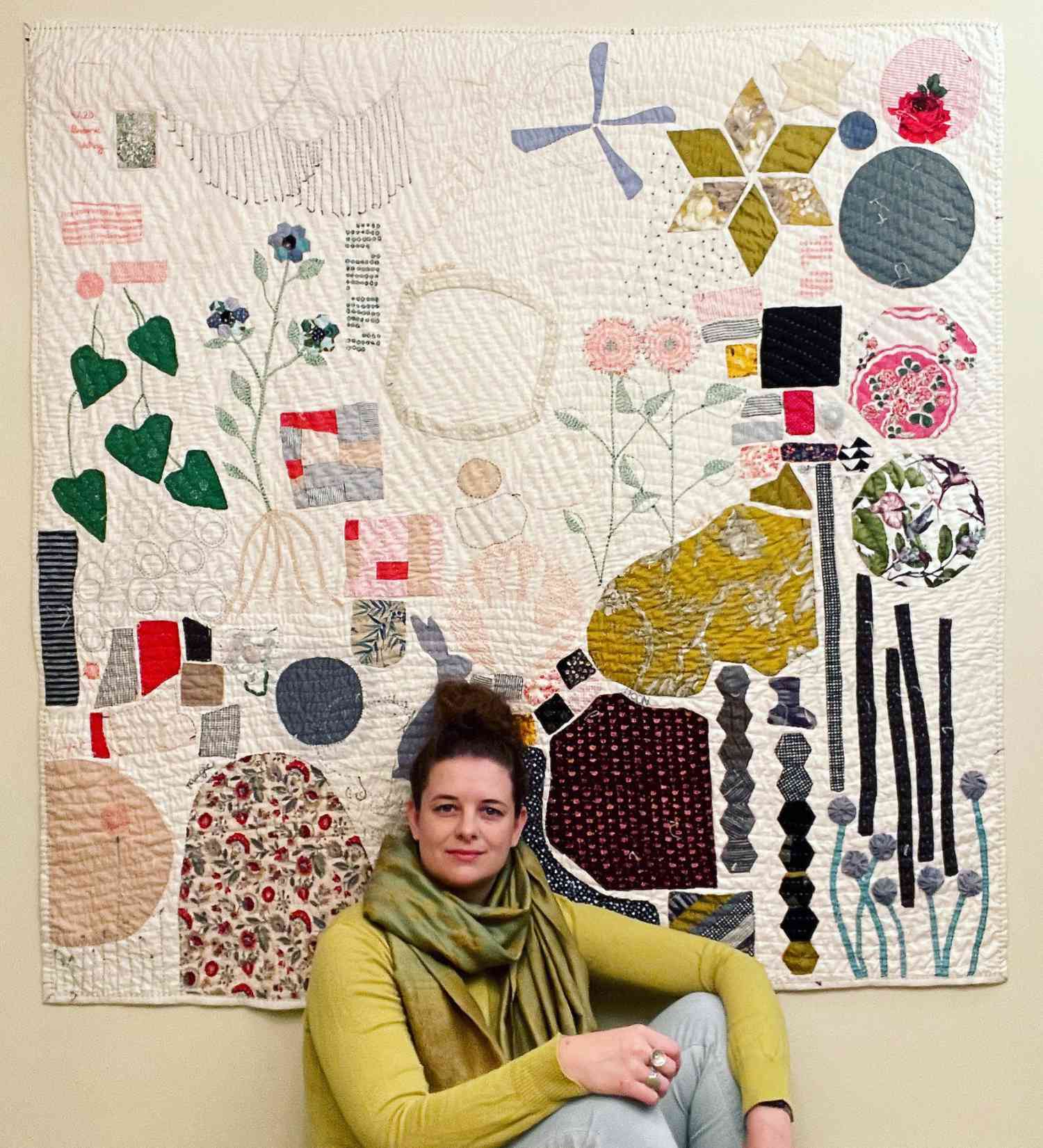 Heidi Parkes portrait sitting in front of quilt