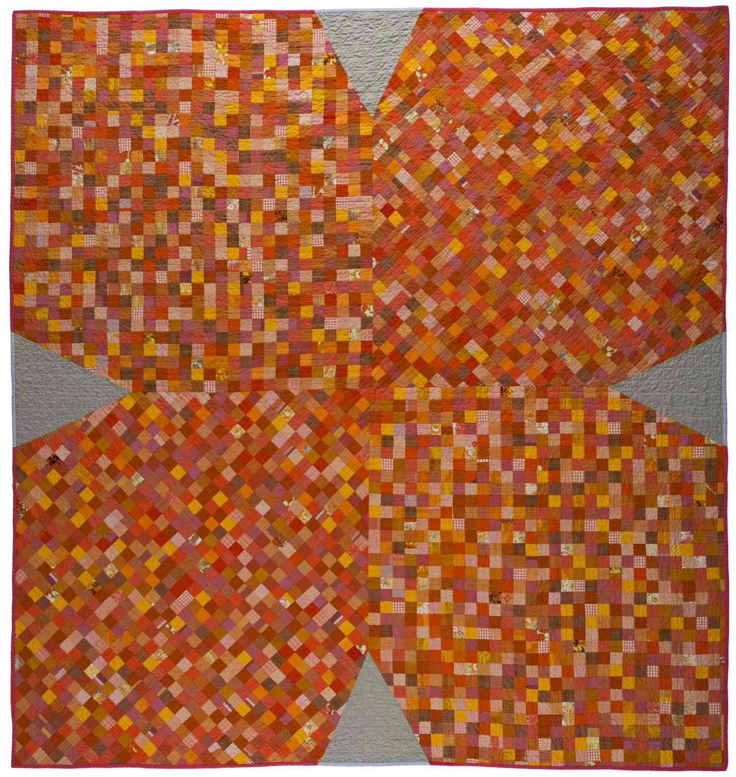 Sarah Nishura orange x-shape quilt with varying shades of orange squares.