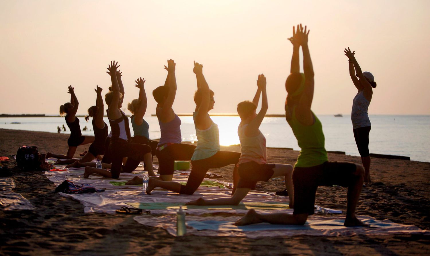 group sunrise yoga on the beach