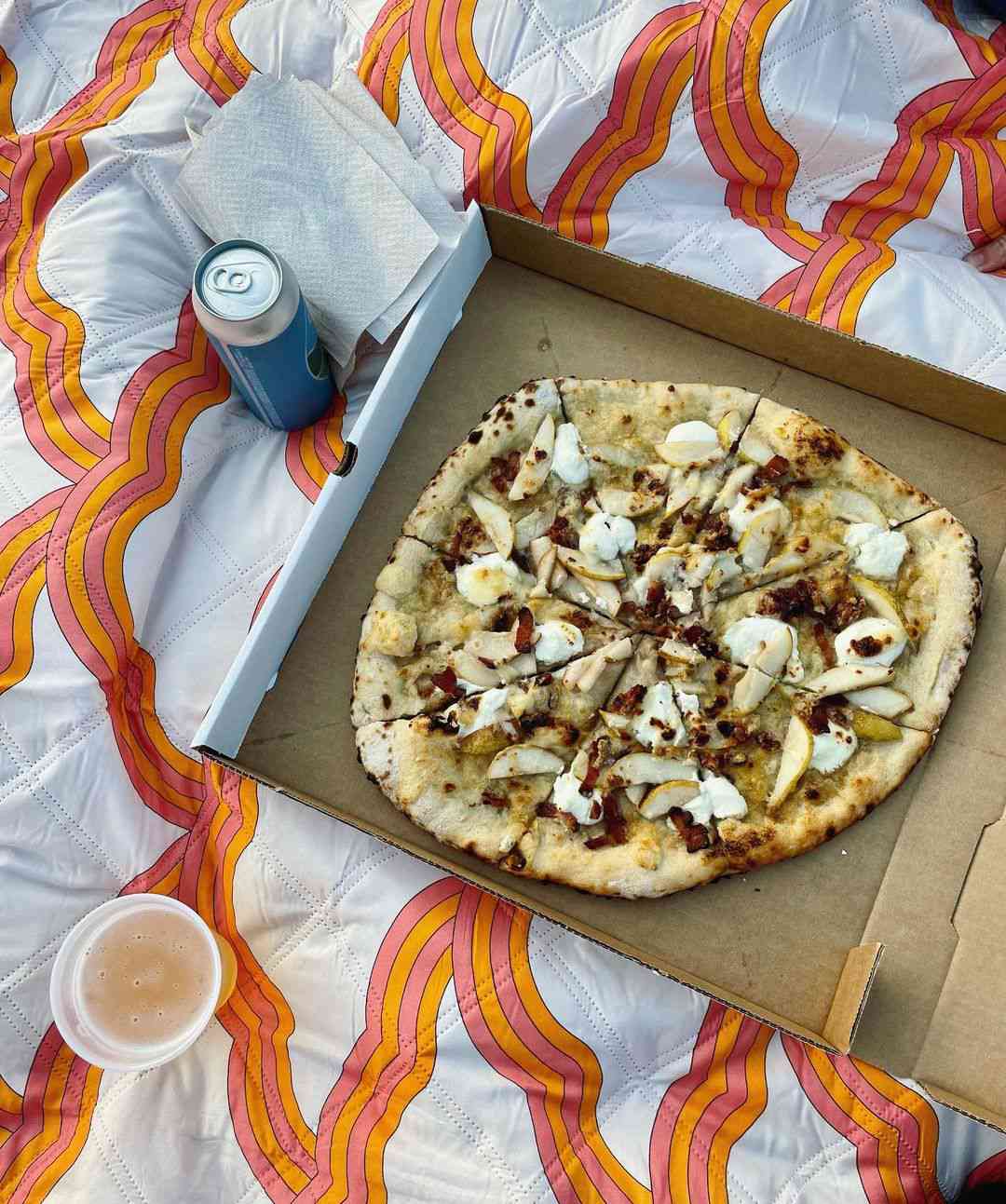box of pizza and drinks on a blanket at Luna Valley Farm