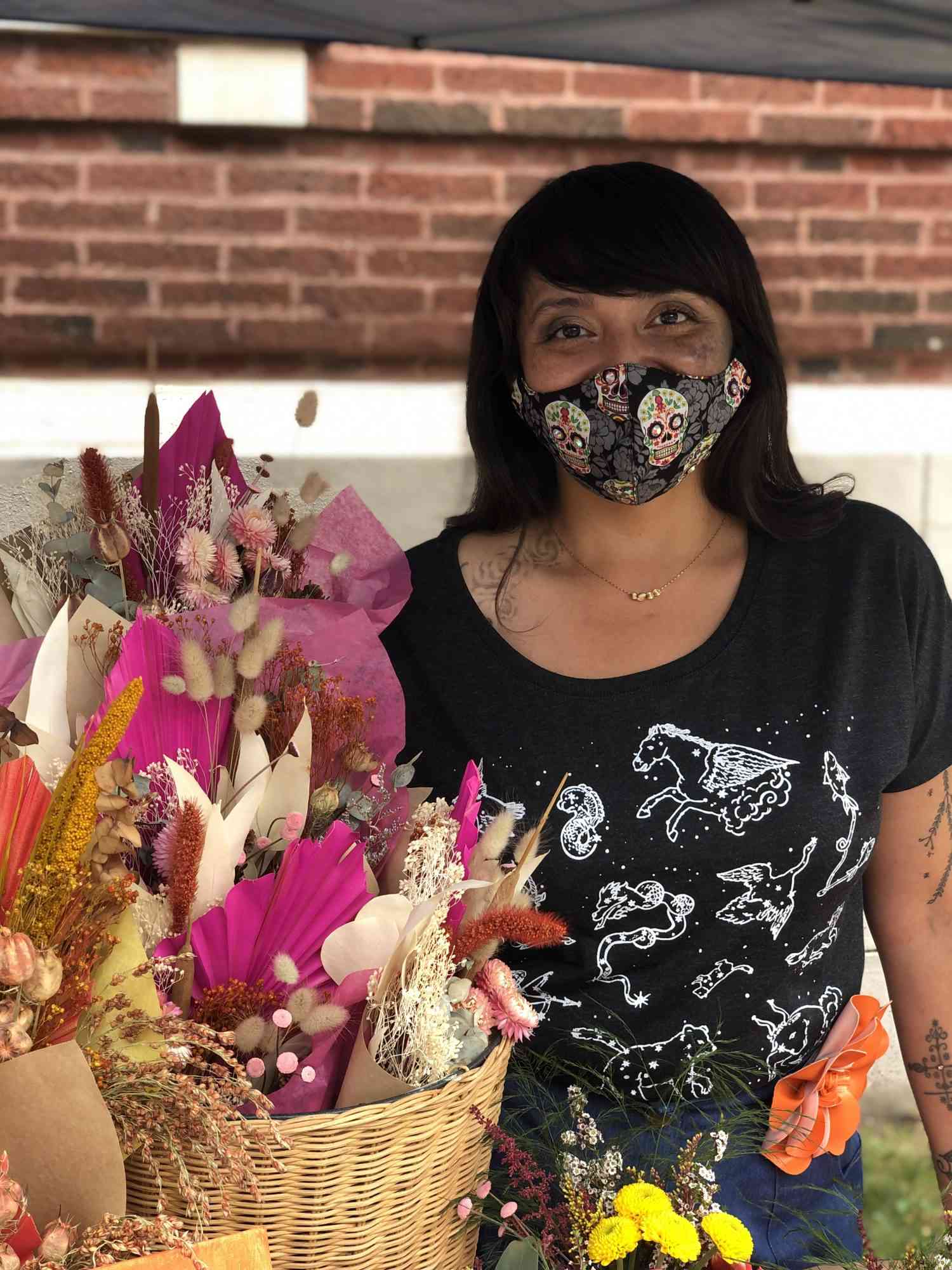 Karina Castellon posing with dried floral bouquets